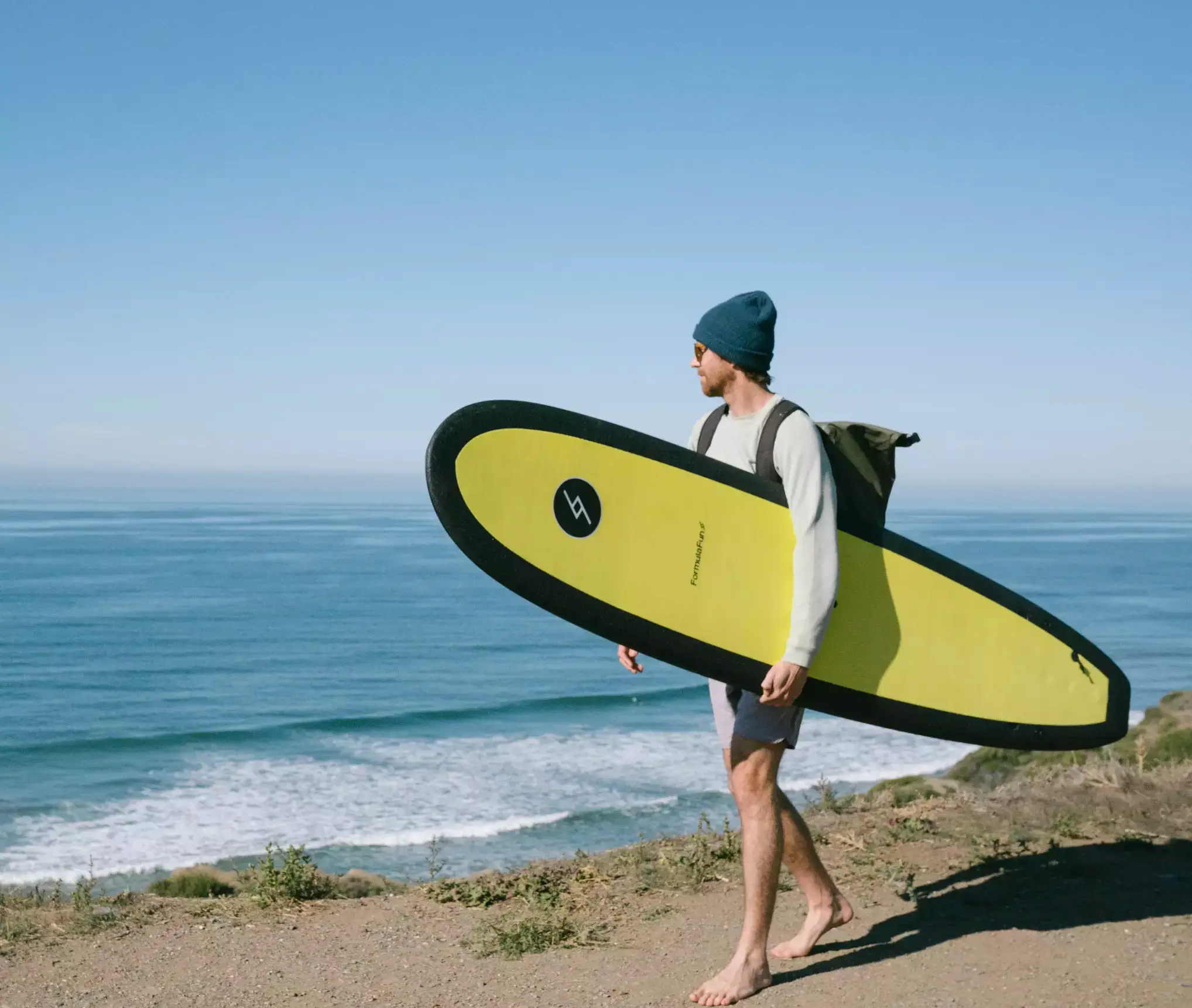 Dakine Surfing Shop -Dakine Surfing Shop man with yellow doho surfboard 2